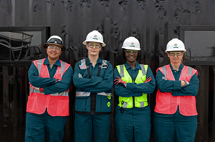 Four Worley women wearing PPE standing together on site.