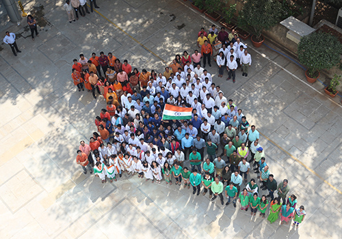 Aerial view of a large group of people from Worley's GID office in India forming a shape.