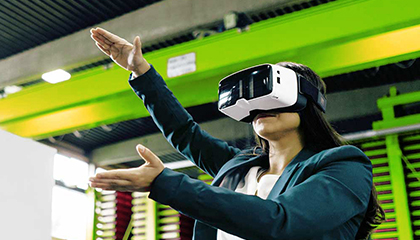 Person wearing a virtual reality headset with arms outstretched.